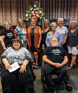 Peggy Lewis in the middle celebrated by Books and Librarians